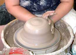 Darlene centers the clay